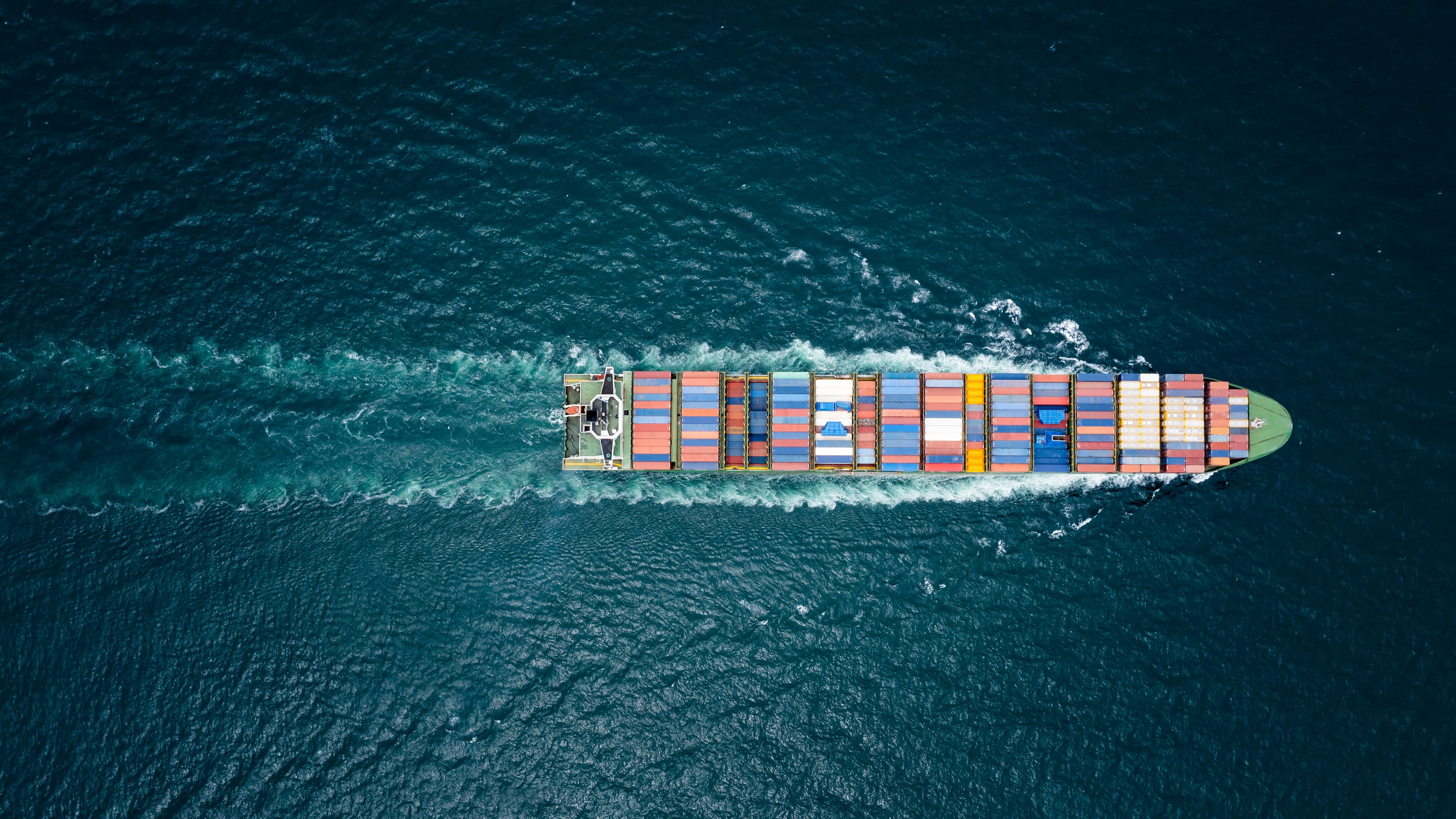 Container vessel navigating open ocean — Waka Tech global logistics